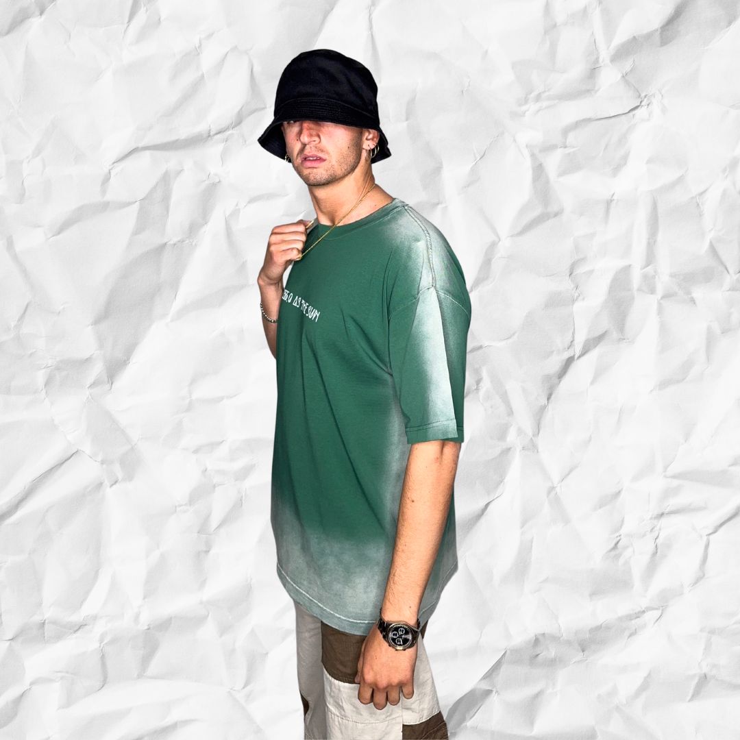 Side profile of model wearing DALTONICO’s Hyperreal Sun Tee in sage green, showing the minimal silhouette and hand-dyed fade detailing.