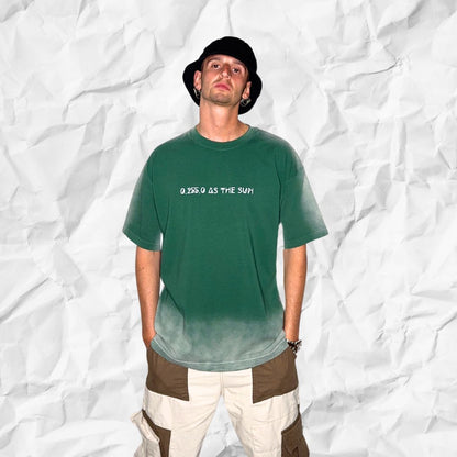 Front-facing pose of model in DALTONICO’s Hyperreal Sun Tee, a sage green oversized streetwear T-shirt challenging perception through code and minimal design.